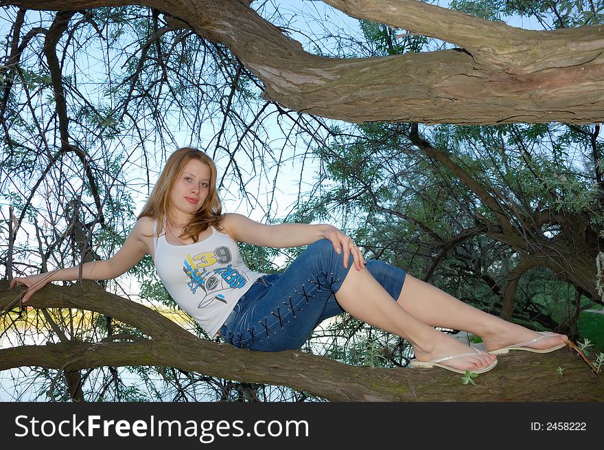 Girl sit on a tree. Girl sit on a tree