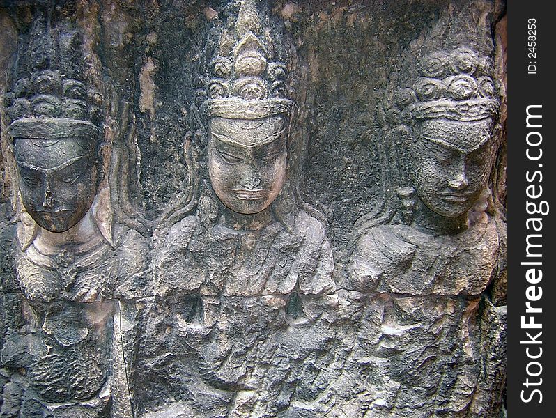 Carving of three dancers in Cambodia's Angkor Wat