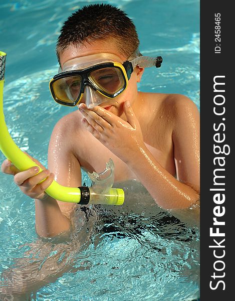 Kid with snorkeling equipment in the water. Kid with snorkeling equipment in the water