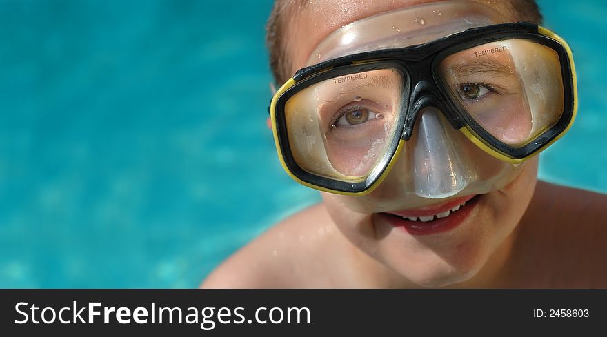Boy in diving mask on a hot summer day; horizontal banner with plenty of space for copy. Boy in diving mask on a hot summer day; horizontal banner with plenty of space for copy