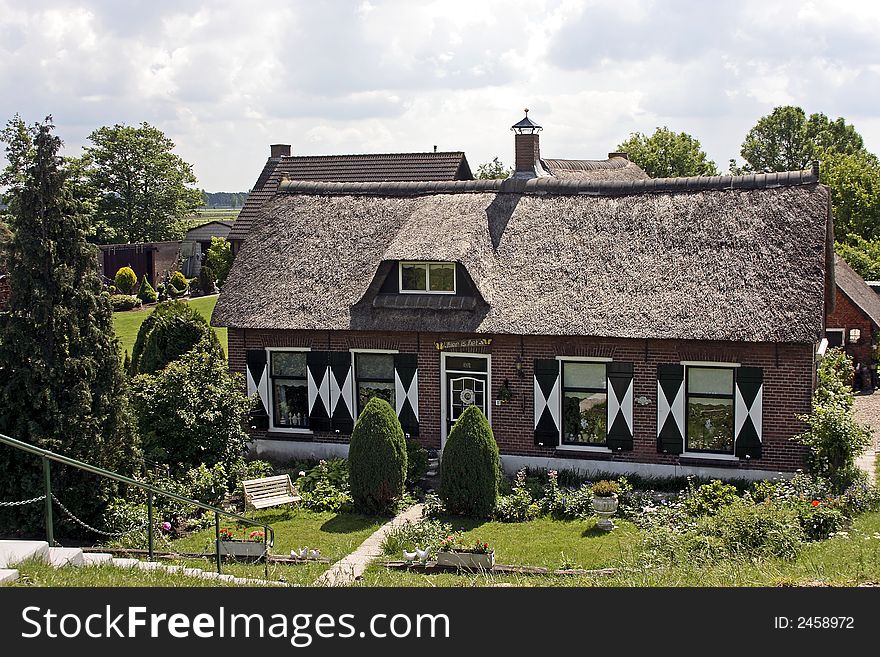 Old farmershouse in the countryside in the Netherlands with a roof from reed. Old farmershouse in the countryside in the Netherlands with a roof from reed