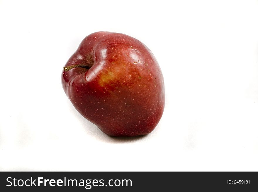 Eating autumn red apple on white background