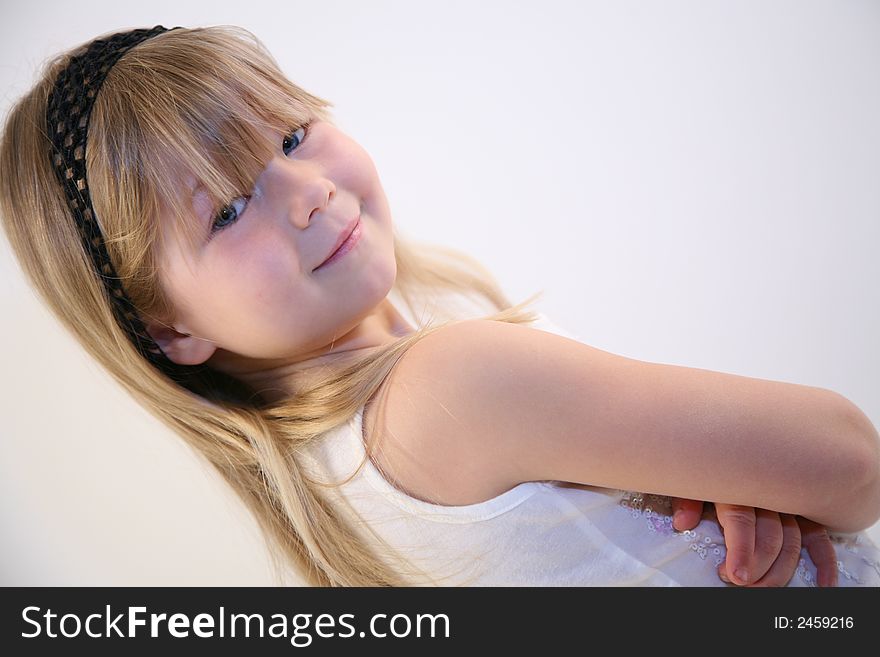 Young girl looking back over her shoulder with her arms folded, showing attitude