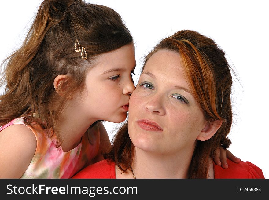 Daughter kissing Mom against a white background