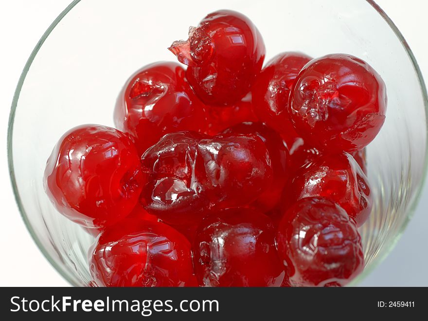 Macro of candied cherries in a glass cup
