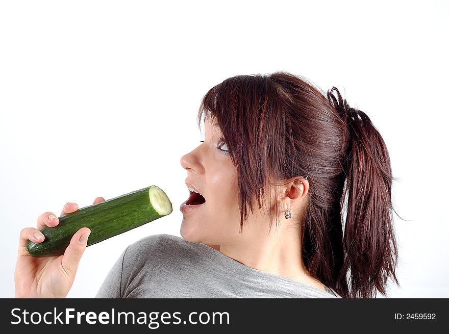 Attractive woman eating cucumber on white background. Attractive woman eating cucumber on white background