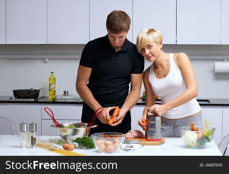 Couple In Their Kitchen Making Dinner
