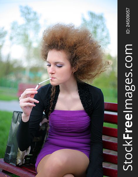 Curly-haired girl with a cigarette