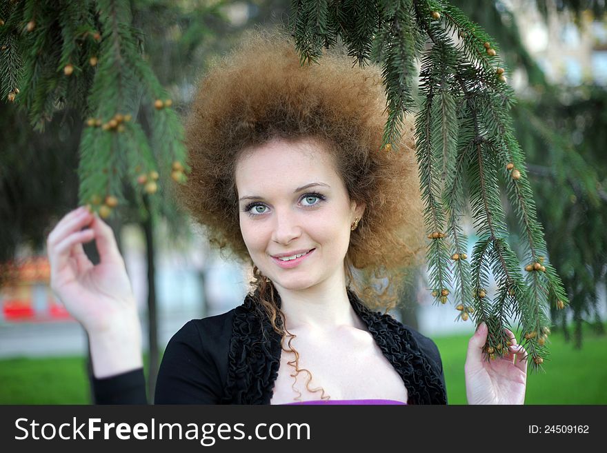 Portrait of a smiling girl in pine trees summer