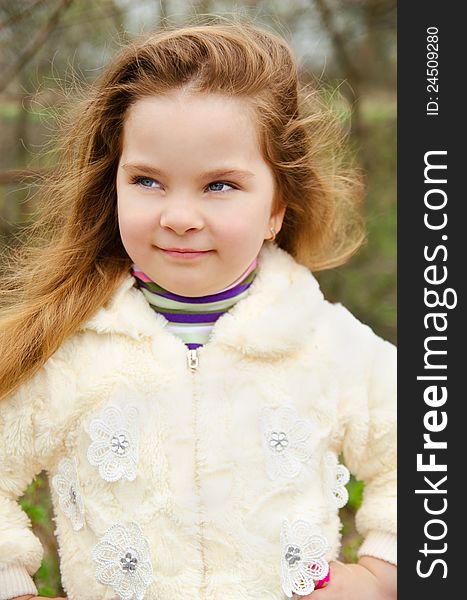 Portrait of little girl outdoors on a spring day