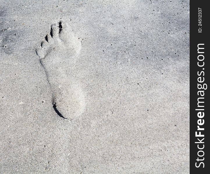 A footprint in the sand gives off an illusion of relief