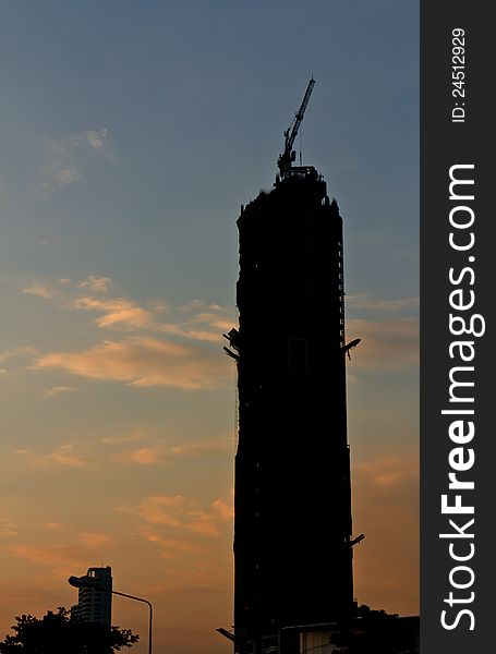 Construction building crane with silhouette