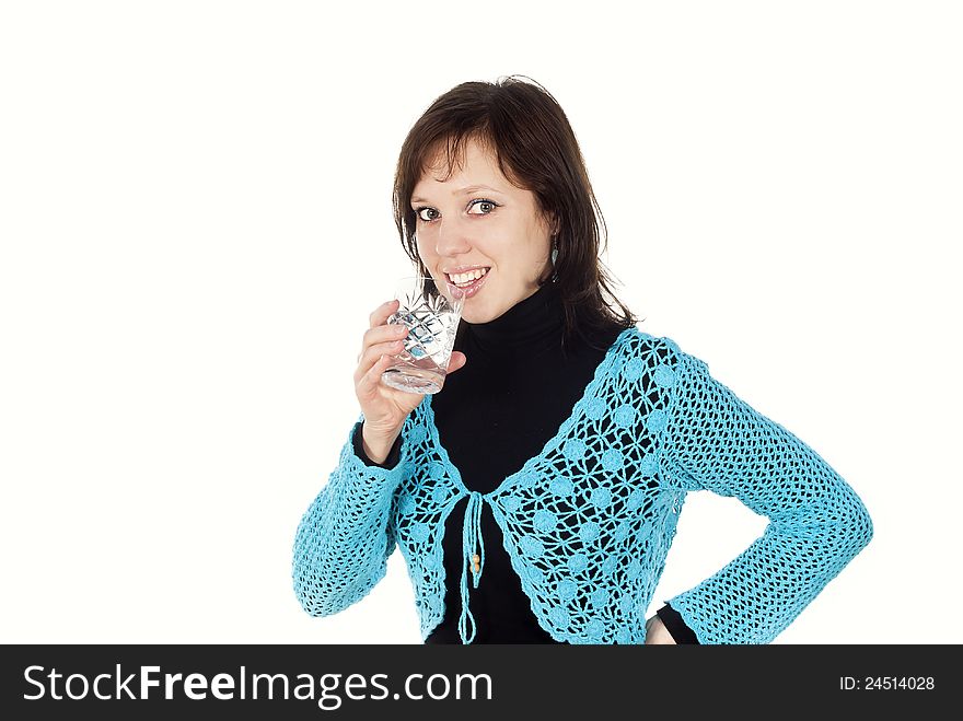 Beautiful happy girl drinks water from a glass