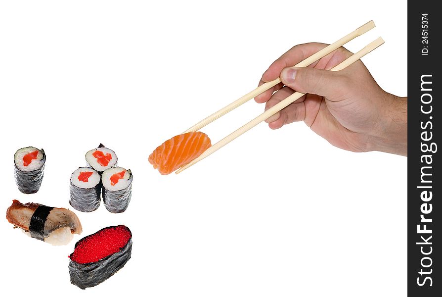 Hand with chopsticks and sushi on white