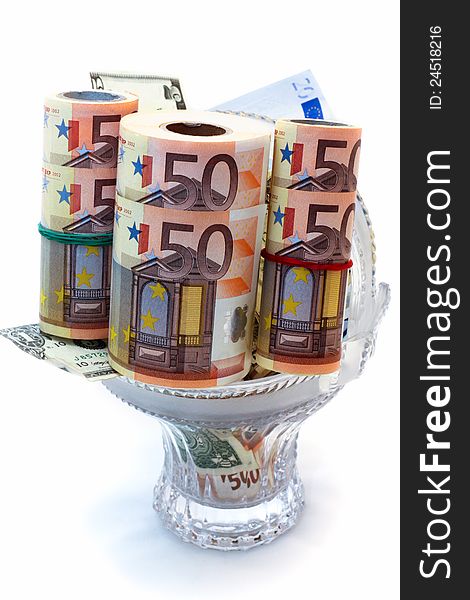Monetary denominations laid in a vase on a white background
