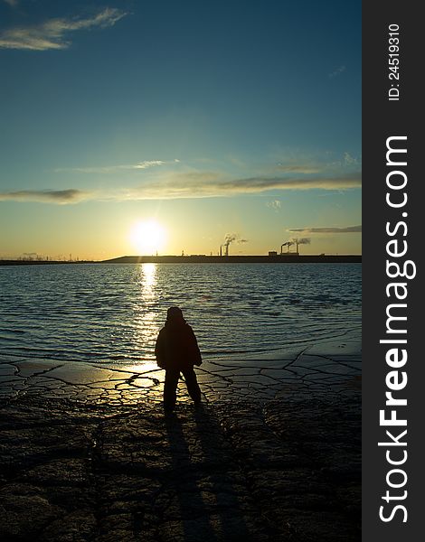 A child on the shore of the lake near the mines. human impact on. A child on the shore of the lake near the mines. human impact on