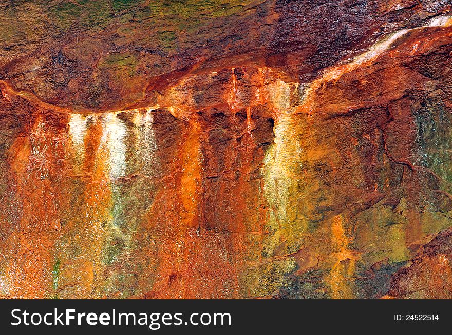 Colorful mineral stains on a limestone wall in a damp canyon in a state park. Colorful mineral stains on a limestone wall in a damp canyon in a state park.