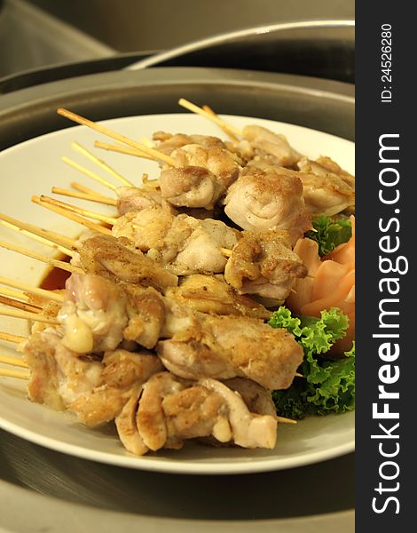 A Grilled chicken skewers in buffet line