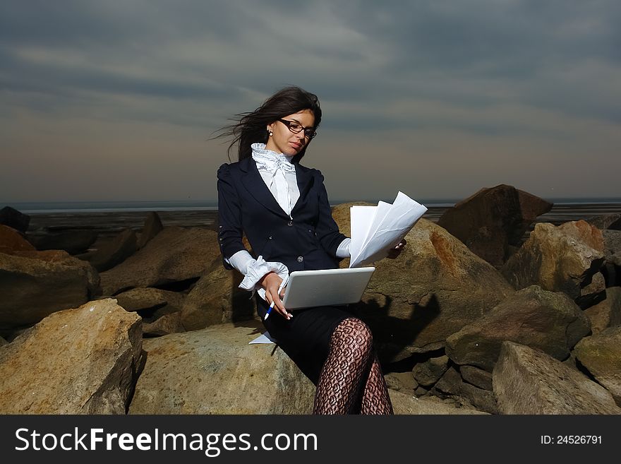 Business Lady Sitting On The Rocks By The Sea, Aga