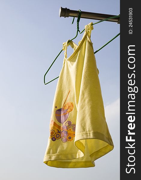 Yellow toddler cloth hanging to dry. Yellow toddler cloth hanging to dry