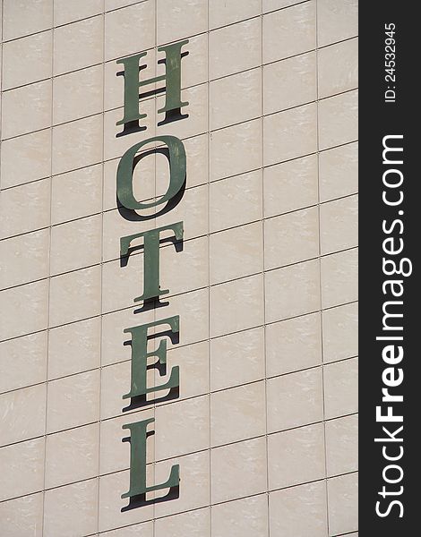 Hotel sign on the building wall.