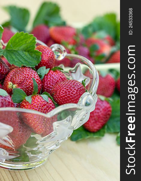 Glass bowl full of ripe and delicious strawberries. Glass bowl full of ripe and delicious strawberries