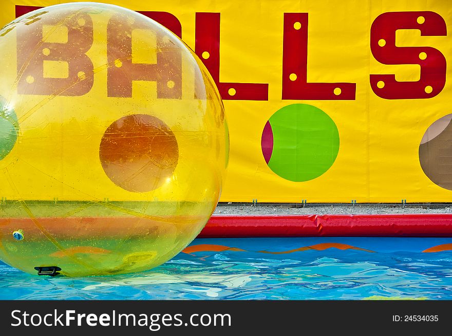 Swimming pool with colored large ballons that come in and have fun. Swimming pool with colored large ballons that come in and have fun