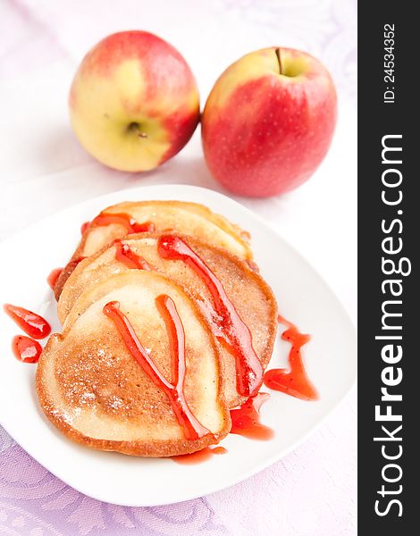 Thick pancakes with sweet red syrup