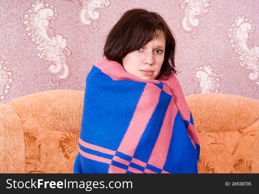 Girl wrapped in a blanket on the couch. Girl wrapped in a blanket on the couch