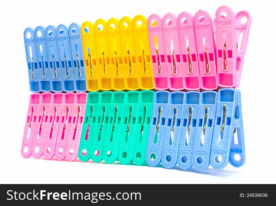 This is the housewares - colorful plastic clothespins on white background. This is the housewares - colorful plastic clothespins on white background