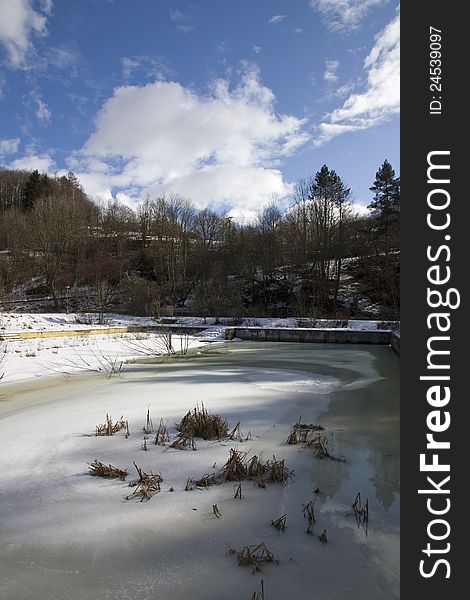 Half drained pond in winter. Half drained pond in winter