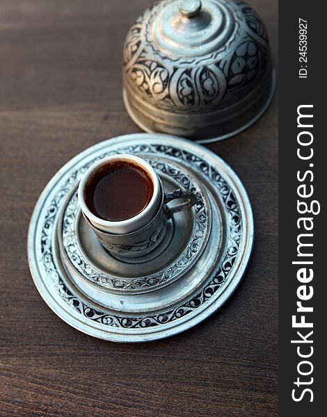 View of Turkish coffee with the decorative copper cup. View of Turkish coffee with the decorative copper cup.