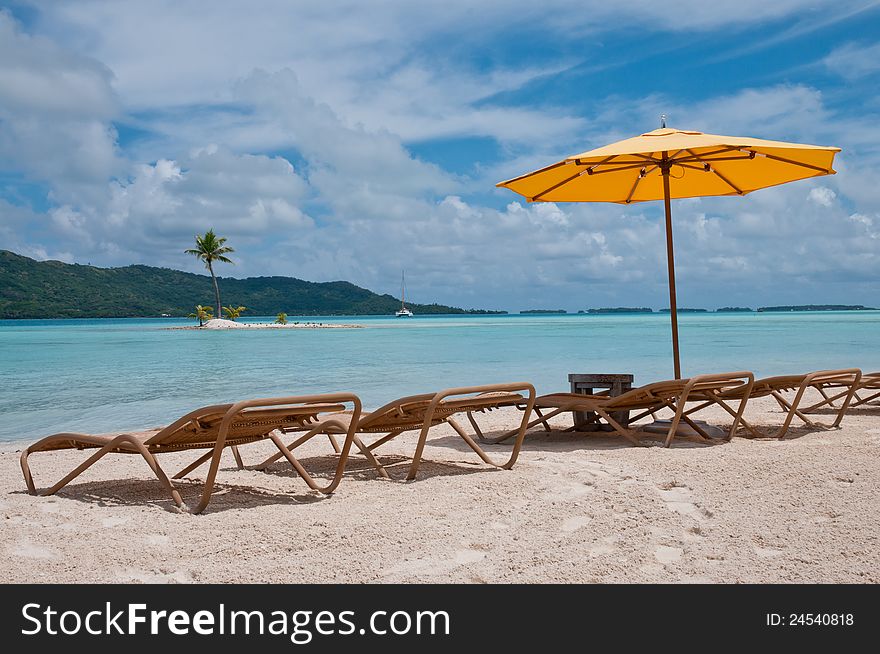 Nice beach with chairs and umbrella in the Polynesia. Nice beach with chairs and umbrella in the Polynesia