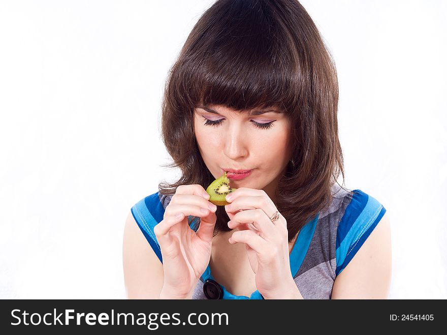 Happy girl eats kiwi isolated. Happy girl eats kiwi isolated