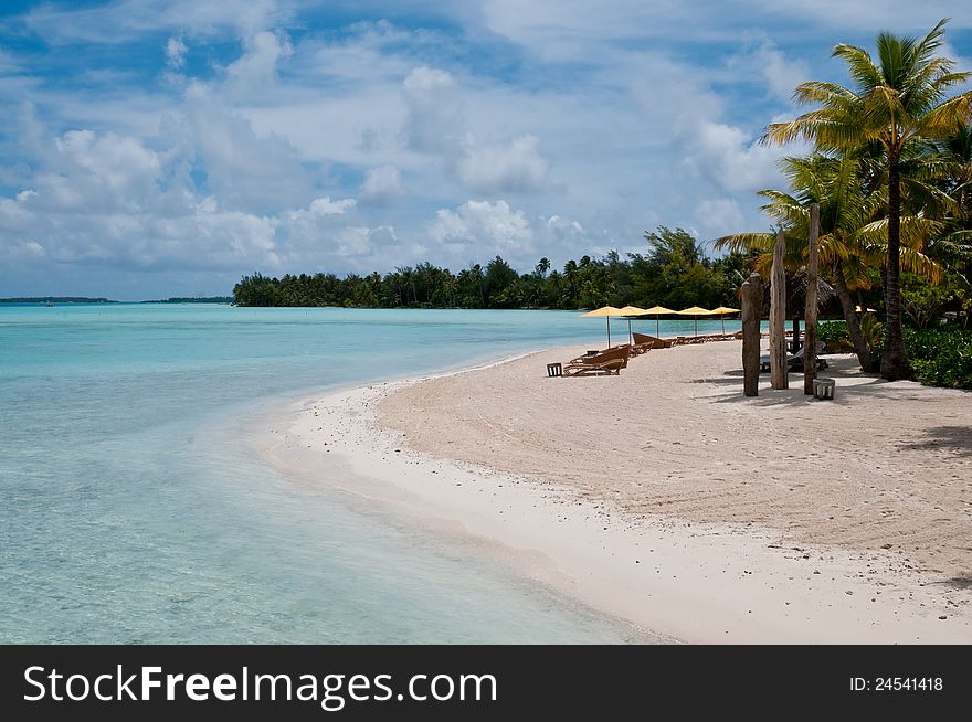 Nice beach with chairs and umbrellas in French Polynesia. Nice beach with chairs and umbrellas in French Polynesia