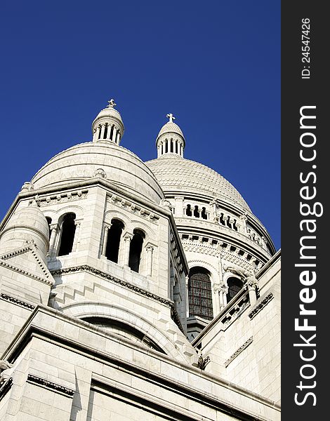 Domes of the Sacre Coeur Basilica in Montmartre, Paris over a deep blue sky. Domes of the Sacre Coeur Basilica in Montmartre, Paris over a deep blue sky