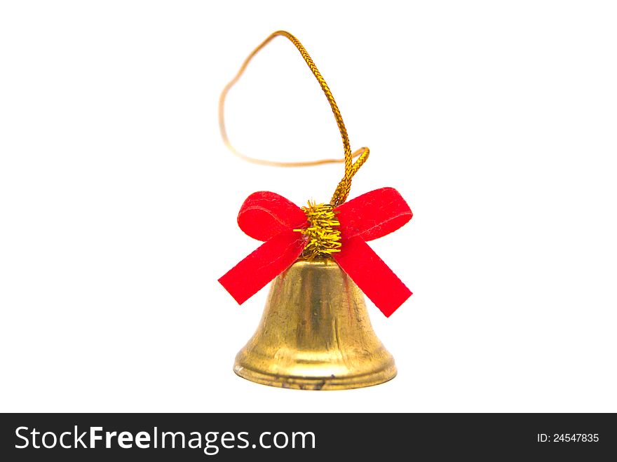 Golden bell with red ribbon close-up