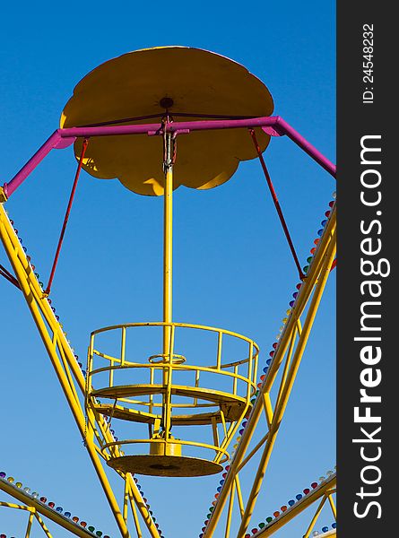 Abandoned empty roundabout isolated on clear blue sky background. Abandoned empty roundabout isolated on clear blue sky background