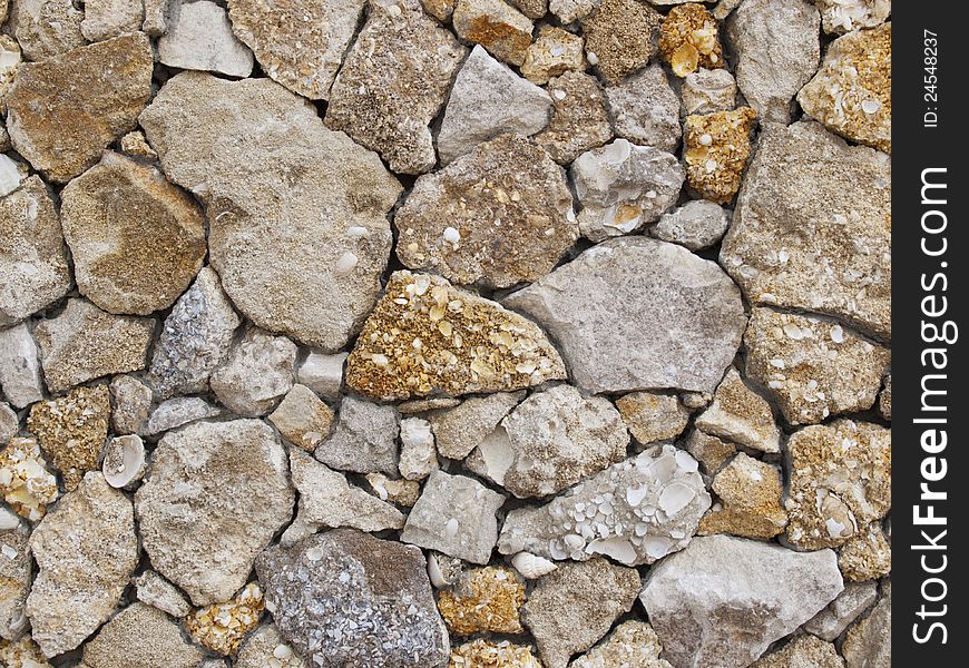 Fence of a natural building material of a yellow shell rock. Fence of a natural building material of a yellow shell rock