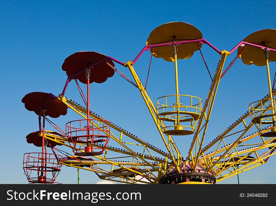 Abandoned empty roundabout isolated on clear blue sky background. Abandoned empty roundabout isolated on clear blue sky background