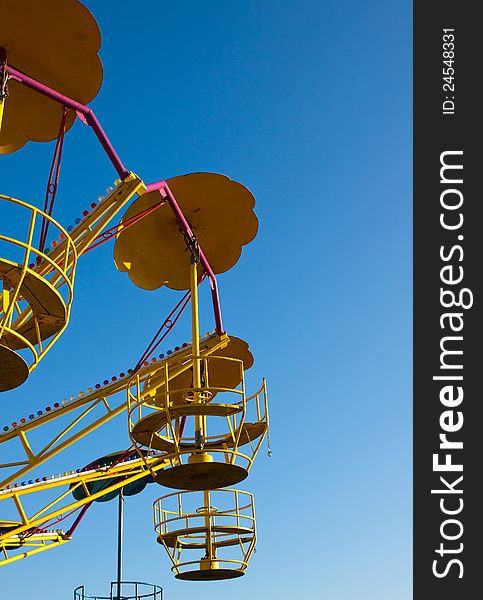 Abandoned empty roundabout isolated on clear blue sky background. Abandoned empty roundabout isolated on clear blue sky background