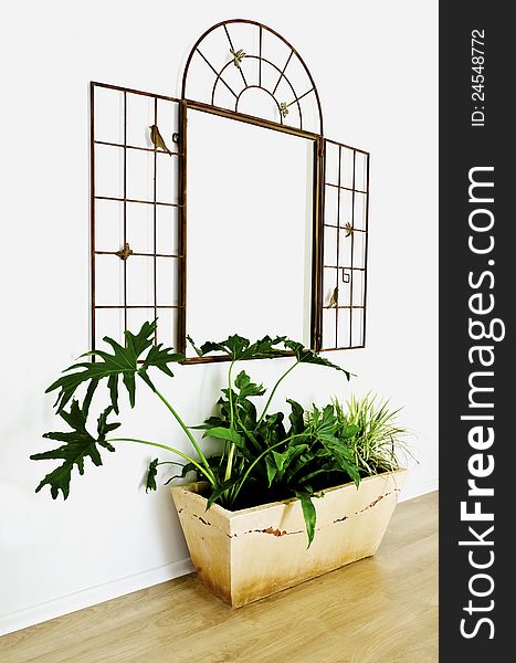 Beautiful mirror with flowerpot in the corridor