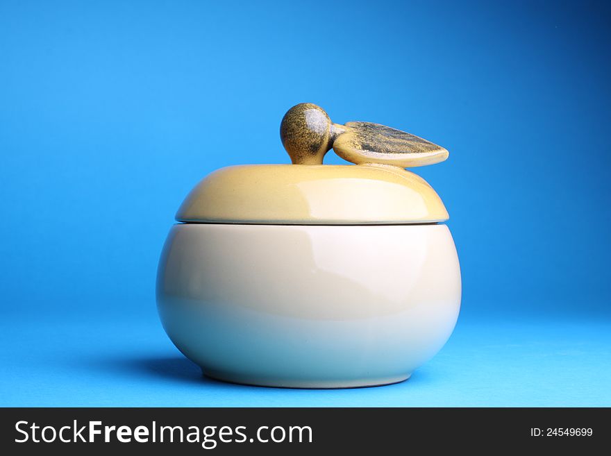 Cup sugar-bowl in the form of an apple isolated on blue background