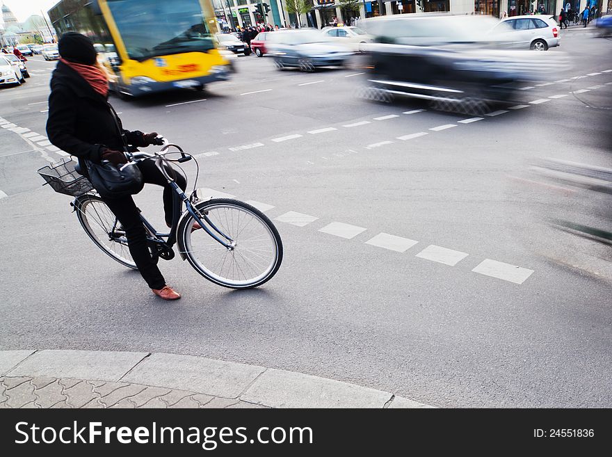 Cyclist Waiting At The Crossroads