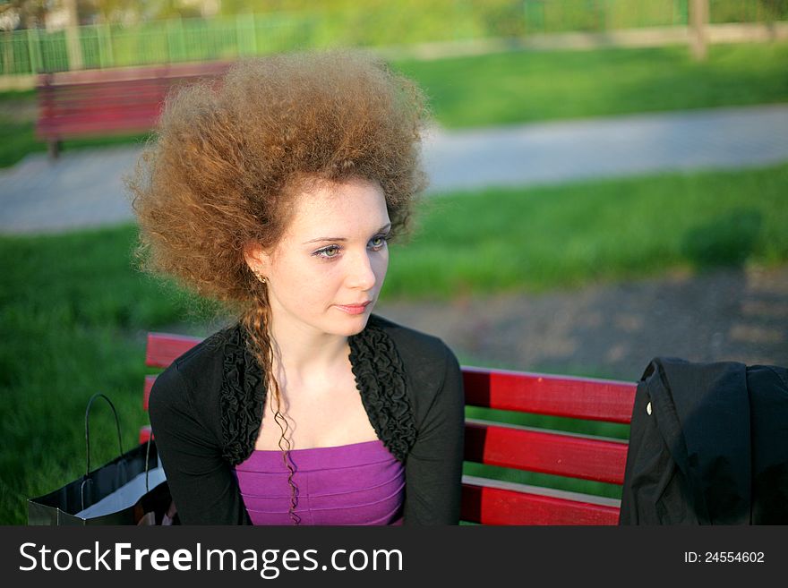 Portrait of pretty redhead girl in the park