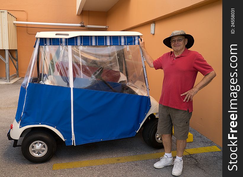 A retired senior citizen man shows off his brand new golf cart at a retirement village in Florida. Toys for boys at any age. A retired senior citizen man shows off his brand new golf cart at a retirement village in Florida. Toys for boys at any age.