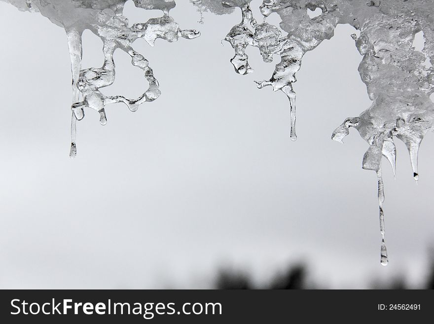 Thawing Icicles against a blue sky. Abstract form. Thawing Icicles against a blue sky. Abstract form.