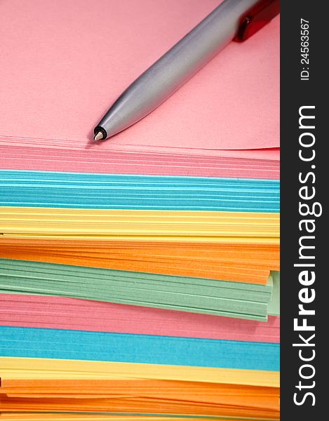 Pen and multi-colored note paper. Pen and multi-colored note paper