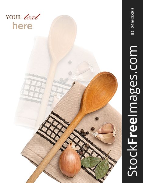 Kitchen towel with wooden spoon, herbs and spices (garlic, pepper, bay leaves). With sample text. Kitchen towel with wooden spoon, herbs and spices (garlic, pepper, bay leaves). With sample text.