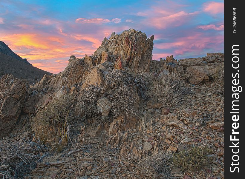Near Death Valley California jagged rocks reach skyward in front of a beautiful, brightly colored sunset in this highly detailed High Dynamic Range image. Near Death Valley California jagged rocks reach skyward in front of a beautiful, brightly colored sunset in this highly detailed High Dynamic Range image.